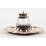 AN EDWARD VII SHAPED OCTAGONAL INKWELL with gadrooned edge with crystal glass ink bottle. London