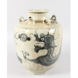 A CHINESE BLUE AND WHITE VASE decorated with dragons and with ring handles. 14ins high.