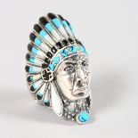 A SILVER INDIAN HEAD RING decorated with turquoise and enamel.