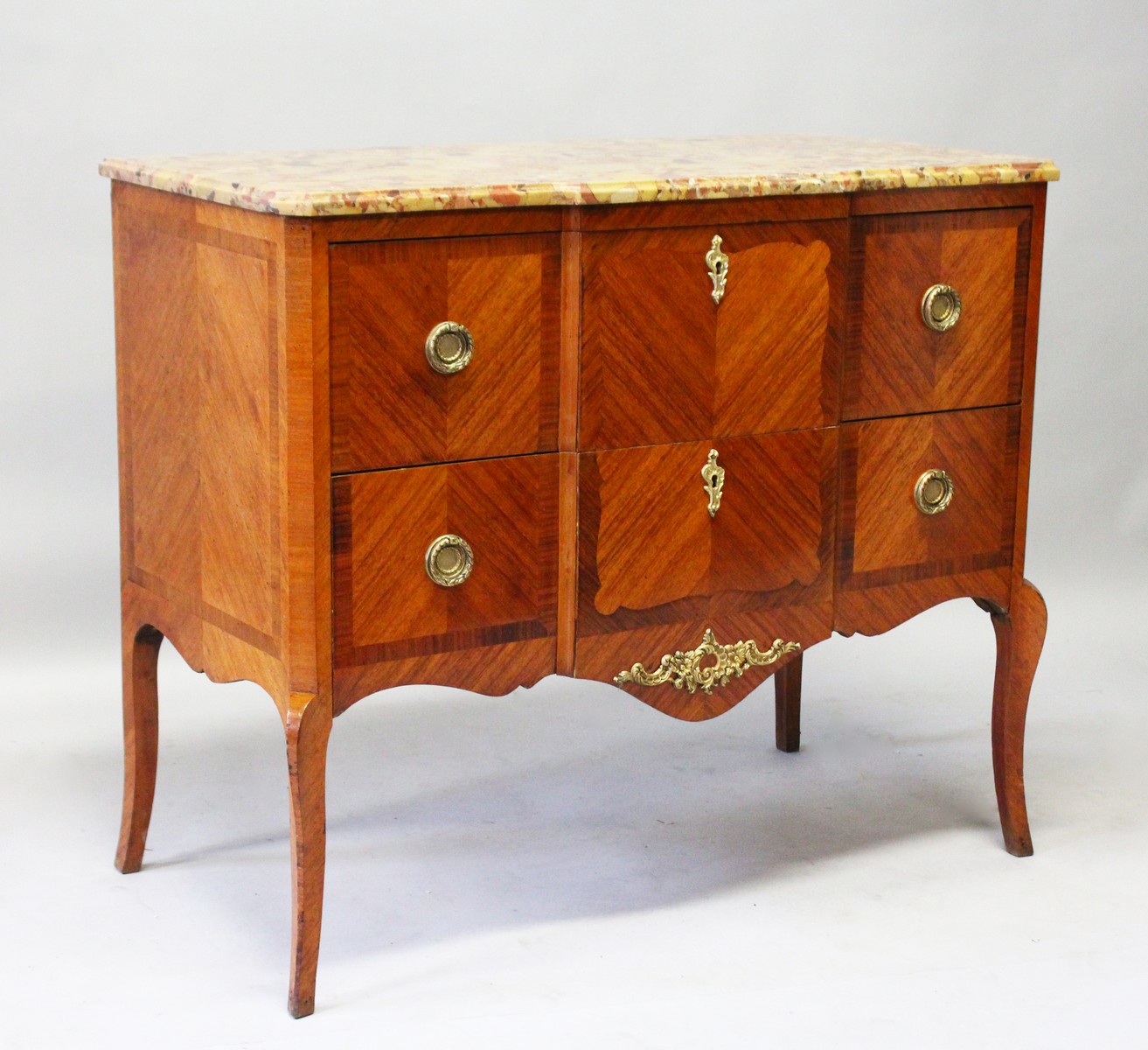 A LOUIS XVIth DESIGN BREAKFRONT TWO DRAWER COMMODE with marble top, ormolu handles, supported on