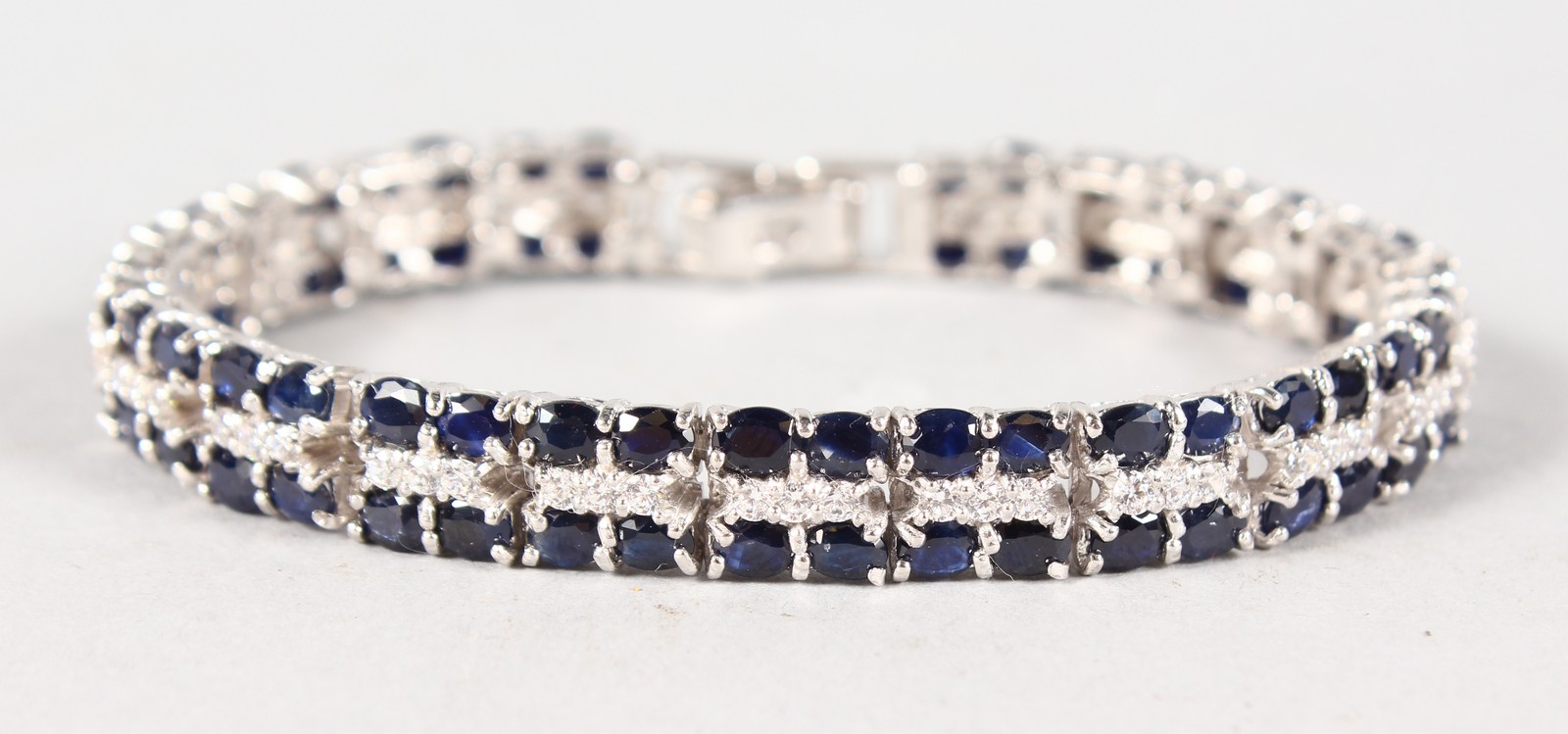A GOOD SILVER, CUBIC ZIRCONIA AND SAPPHIRE DOUBLE ROW BRACELET.