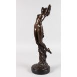 AFTER O. SOLEMAE A STANDING BRONZE NUDE. Signed, on a circular marble base. 18ins high.