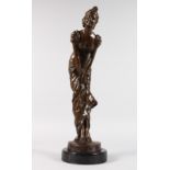 AFTER E. NAHCEAL A BRONZE OF A YOUNG LADY leaning forward. Signed, on a circular marble base.