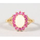 A 9CT GOLD, OPAL AND RUBY DRESS RING.