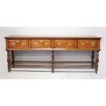 A GOOD 18TH CENTURY OAK DRESSER BASE with plain top, four deep drawers with pierced brass handles