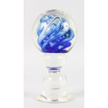 A HEAVY BLUE SWIRL DECORATED GLASS WIG STAND. 7ins high.