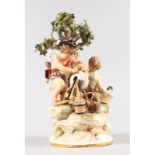 A GOOD MEISSEN GROUP OF TWO CUPIDS sharpening a knife on a wheel beneath a tree. Cross swords mark