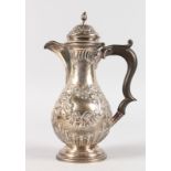 A SMALL COFFEE POT with repousse decoration and wooden handle. Chester 1902.