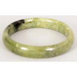A CHINESE PALE SPINACH GREEN JADE BANGLE, 2.8in diameter, the inner rim 2.25in diameter.