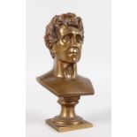 A BRONZE BUST OF A MAN on a square pedestal. Signed Louget. 7.5ins high.