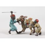 A SMALL VIENNA PAINTED COLD CAST GROUP, TWO MEN WITH A STUBBORN DONKEY. 4ins long.