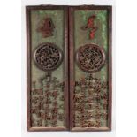 A PAIR OF LONG UPRIGHT WOODEN PLAQUES, carved with calligraphy. 31ins high, 10ins wide.