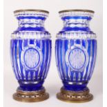 A GOOD PAIR OF FRENCH BLUE TINTED CRYSTAL VASES, three cut glass ovals and metal mounts. 11ins