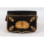 AN 18TH CENTURY FRENCH MILITARY LEATHER POUCH with ormolu mounts and edges, with long leather