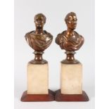 A GOOD PAIR OF BRONZE BUSTS on marble and wooden stands. 13ins high.