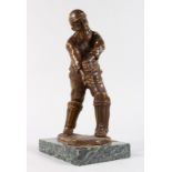 A BRONZE OF A CRICKET PLAYER by W. G. GRACE on a marble base. Note: Lacking his bat. 10ins high.