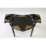 A JENNENS & BETTRIDGE VICTORIAN BLACK LACQUER SHAPED LOO TABLE on tapering legs. 2ft 4ins, 1ft