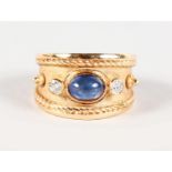 A 9CT YELLOW GOLD, DIAMOND AND CABOCHON SET SAPPHIRE RING.