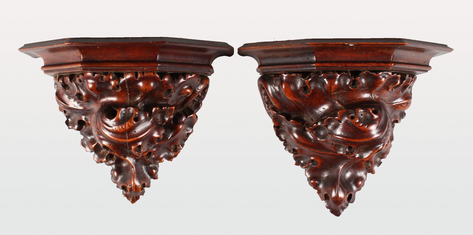A GOOD PAIR OF 18TH CENTURY CARVED WALNUT WALL BRACKETS with naturalistic carved supports. 7ins x