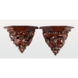 A GOOD PAIR OF 18TH CENTURY CARVED WALNUT WALL BRACKETS with naturalistic carved supports. 7ins x