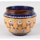 A ROYAL DOULTON STONEWARE JARDINIERE with blue rim and ribbed body with flowers. 9ins diameter.
