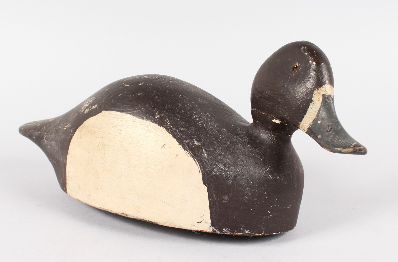 A PAINTED DECOY DUCK with lead weight. 14ins long.