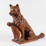 A GOOD BLACK FOREST CARVED WOOD SEATED DOG, his paw on a plaque. 15ins high x 19ins long.