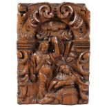 A SMALL 17TH CENTURY OAK CARVING, two figures in an arch surrounded by scrolls. 11ins x 7.5ins.