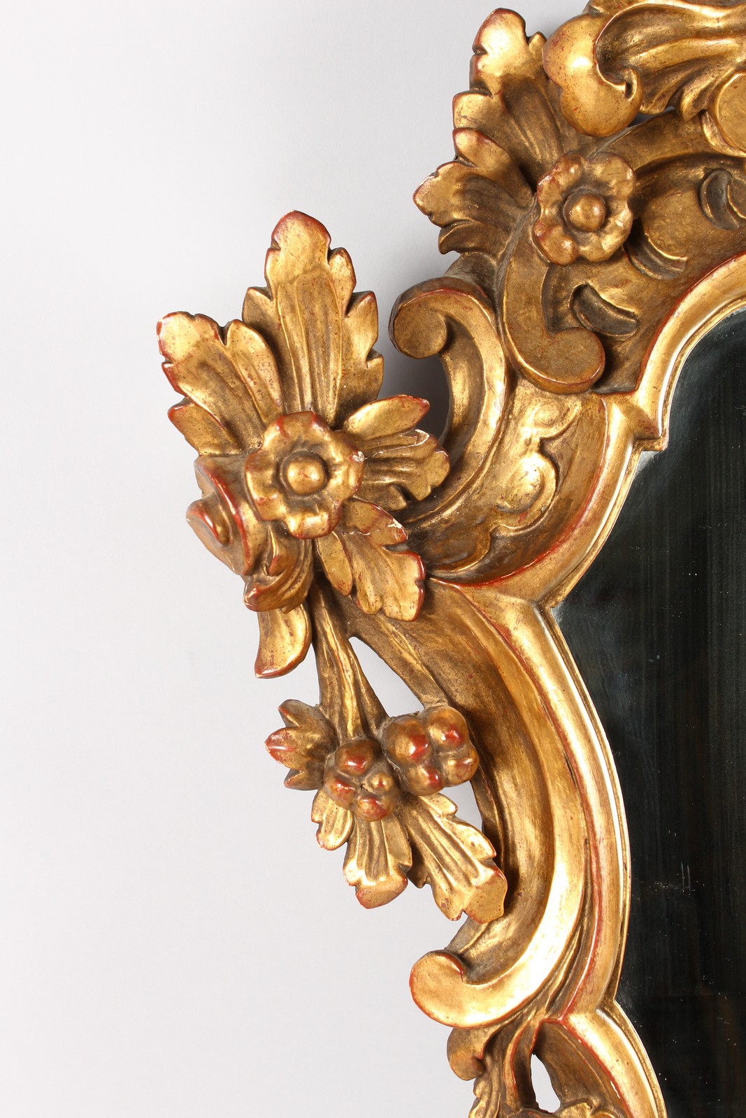 A PAIR OF ITALIAN SHAPED AND CARVED GILTWOOD MIRRORS with acanthus and flower heads. 2ft 5ins long. - Image 3 of 4