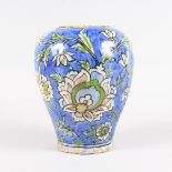 AN IZNIK POTTERY VASE, decorated with stylised flowers. 8.5ins high.