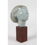 AN ANCIENT EGYPTIAN CARVED GREY MARBLE BUST. 4ins high, on a wooden plinth.