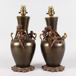 A PAIR OF 19TH CENTURY FRENCH BRONZE VASES, converted to lamps with female figures and cherubs on