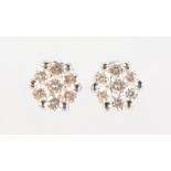A PAIR OF 18CT GOLD DIAMOND SET CLUSTER EARRINGS comprised of seven brilliant cut diamonds.