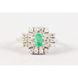 AN 18CT WHITE GOLD, DIAMOND AND EMERALD SET RING.