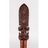 A GOOD MAORI WOODEN PADDLE of good colour, with carved top with two mother-of-pearl eyes either