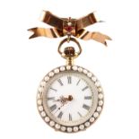 A LADIES GOLD FOB WATCH surrounded by seed pearls with gold bow brooch.