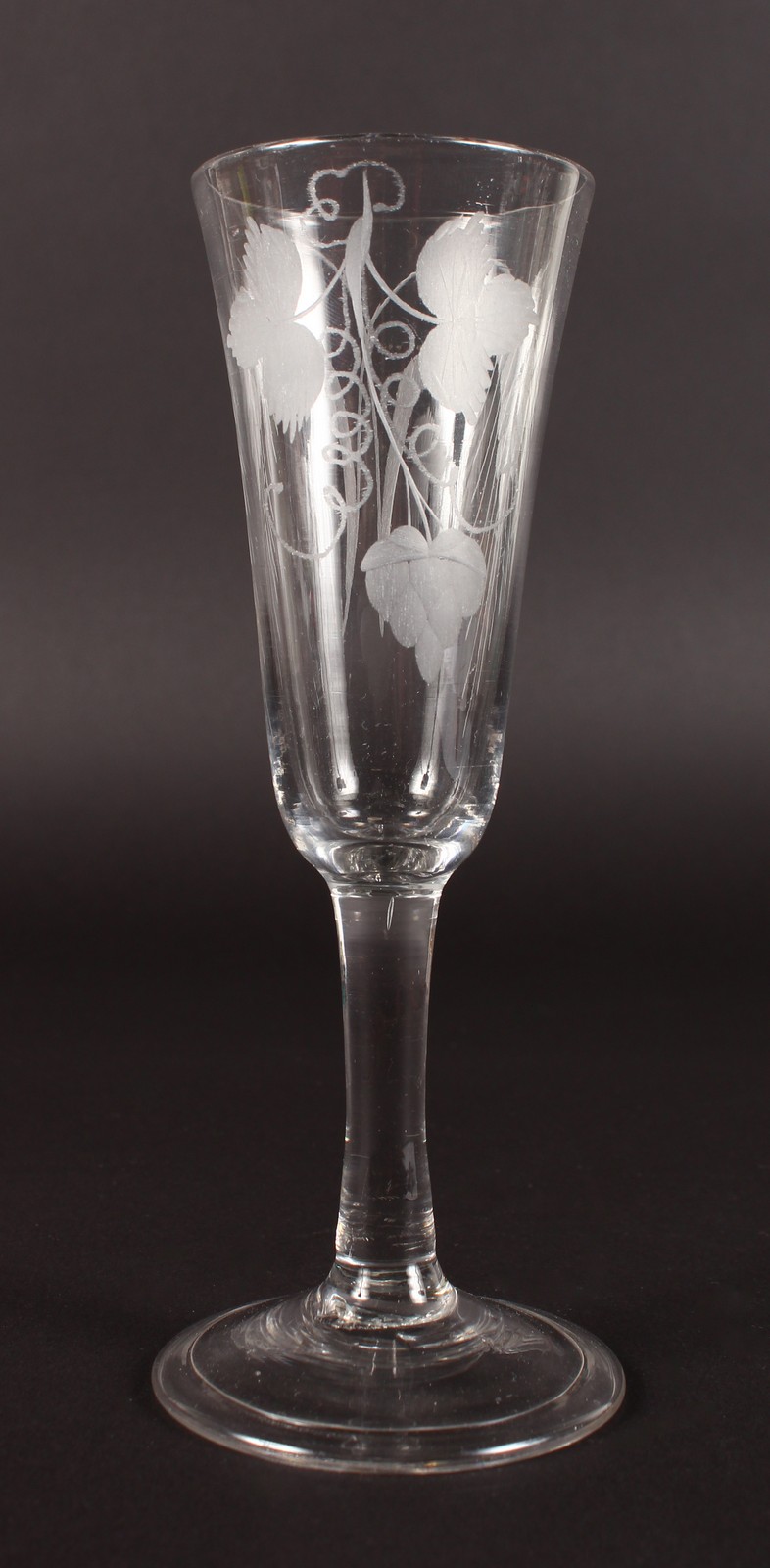 AN ALE GLASS, the bowl engraved with fruiting vines. 6.5ins high.