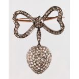 A GOOD ROSE DIAMOND HEART SHAPED BROOCH with RIBBON.