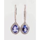 A PAIR OF 14K WHITE GOLD AND DIAMOND EARRINGS SET WITH OVAL CUT TANZANITES, approx. 1.47ct total