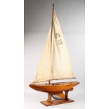 A LARGE EARLY WOODEN POND YACHT, called TINY. 3ft long.