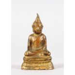 A SMALL BRONZE BUDDHA, traces of gilding. 2.5ins high.