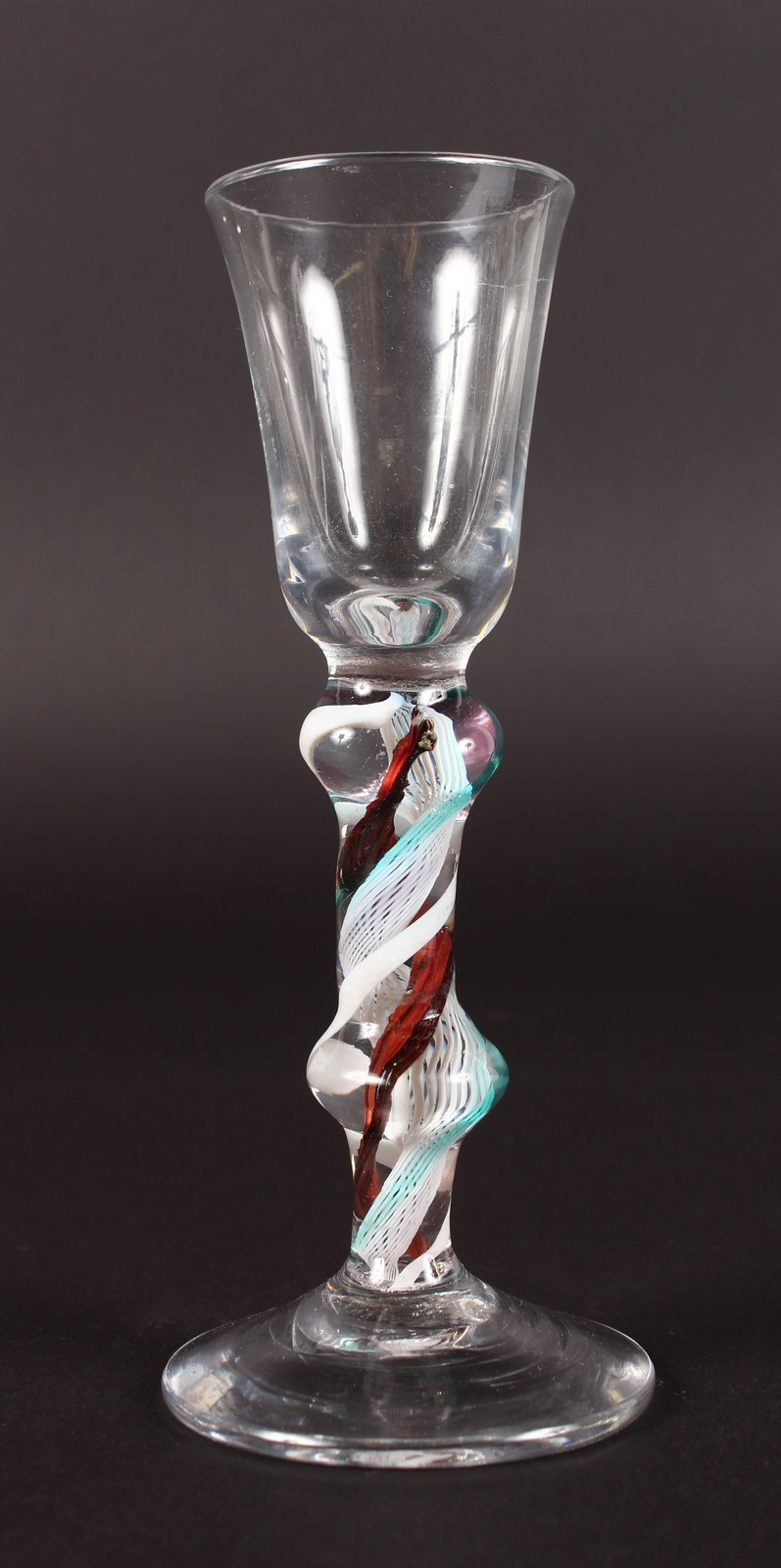 A CORDIAL GLASS, the knop stem with coloured twist. 5.5ins high.