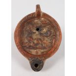 TERRA COTTA ROMAN OIL LAMP, 5ins long, the top with figures and a dog.