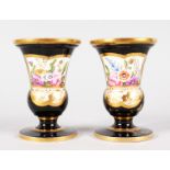 A SMALL PAIR OF SPODE URN SHAPED VASES with rich blue ground edges in gilt and painted with a