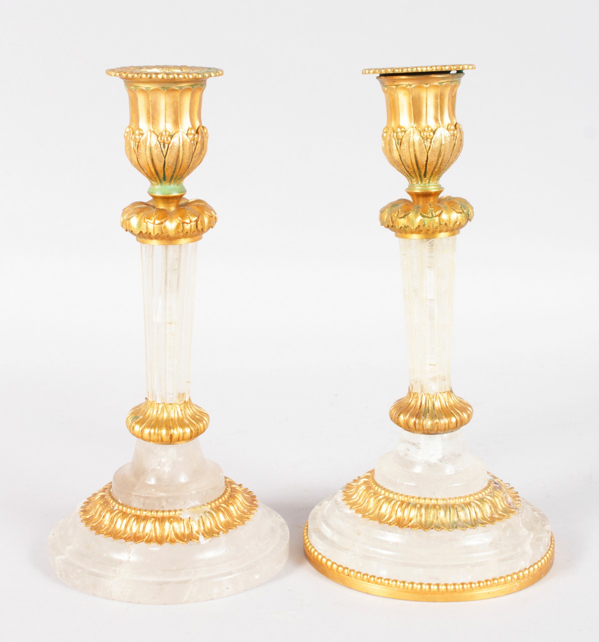 A GOOD PAIR OF ROCK CRYSTAL ORMOLU MOUNTED CIRCULAR CANDLESTICKS. 7.75ins high.