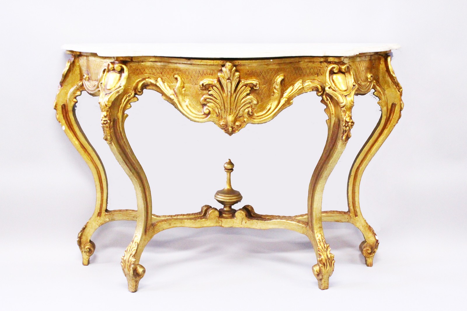 A CARVED, GILDED, MARBLE CONSOLE TABLE IN 18TH CENTURY STYLE, of serpentine outline on four