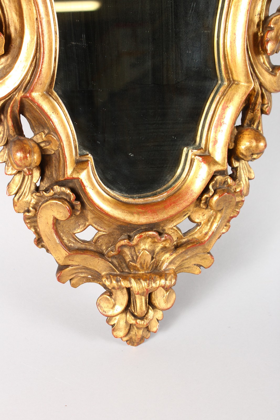 A PAIR OF ITALIAN SHAPED AND CARVED GILTWOOD MIRRORS with acanthus and flower heads. 2ft 5ins long. - Image 4 of 4