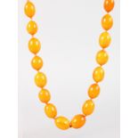 STRING OF EGG YOLK AMBER BEADS, thirty nine beads.