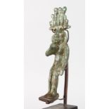 A GRAND TOUR BRONZE EGYPTIAN FIGURE on a wooden stand. 5.5ins high.