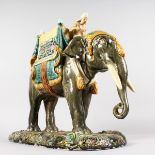 A LARGE MAJOLICA GROUP OF AN ELEPHANT AND RIDER, POSSIBLY MINTON, with blue, green and yellow